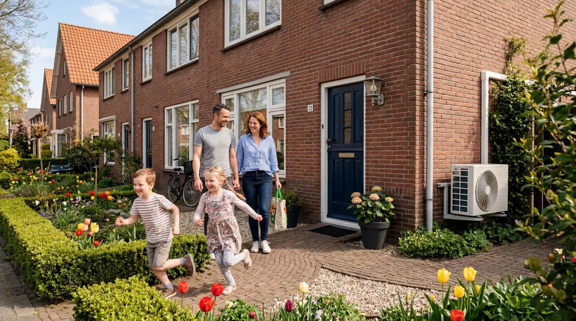 Couple in the garden of a Dutch home with a heat pump outdoor unit